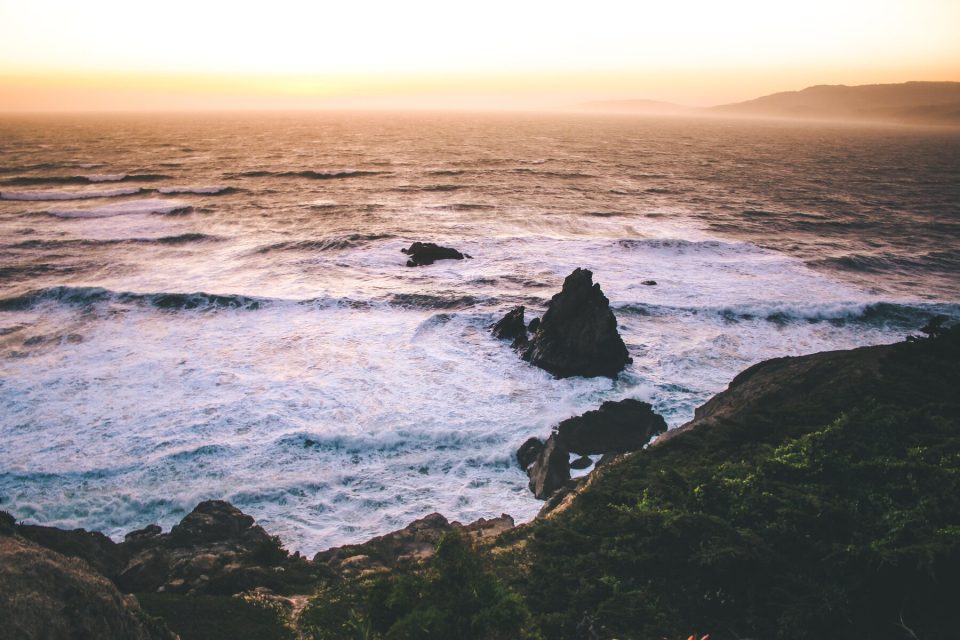 Pacific surf breaking around rocks below the Lands End headland in San Francisco